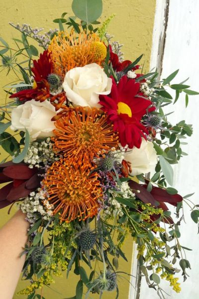 Wedding bouquet with fall flowers and greenery