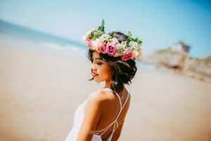 bride with floral wreath on the beach