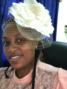 black woman with ivory veiled hat