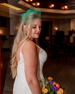 bride wearing a green birdcage veil