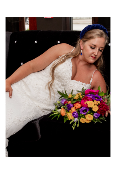 riding wearing a navy blue headband and with an eclectic bridal bouquet