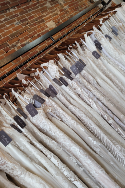 a rack of wedding dresses