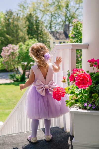Flower girl in a lavender dress with flower fascinator
