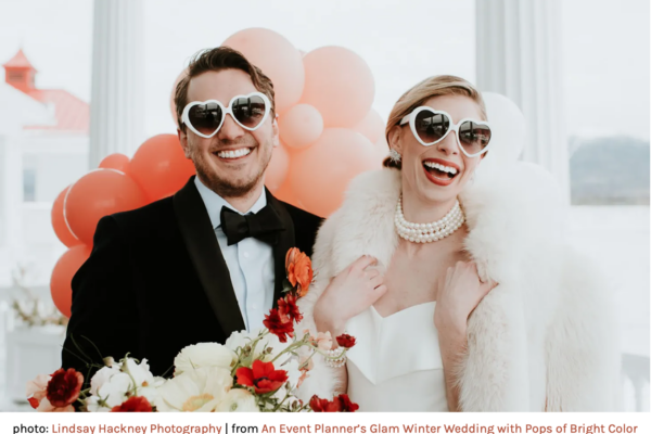 bridal couple wearing white heart shaped sunglasses