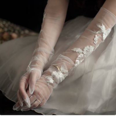 bride wearing sheer gloves and lace appliqués