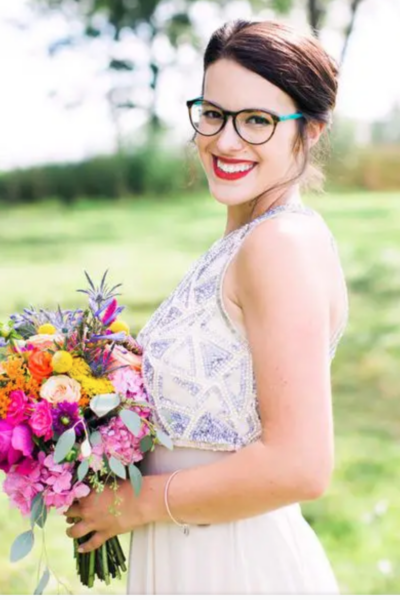 bride wearing glasses with her wedding dress