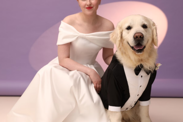 bride posing with her dog in wedding attire