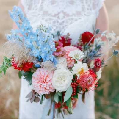 bride holding rustic assortment of flowers bridal bouquet