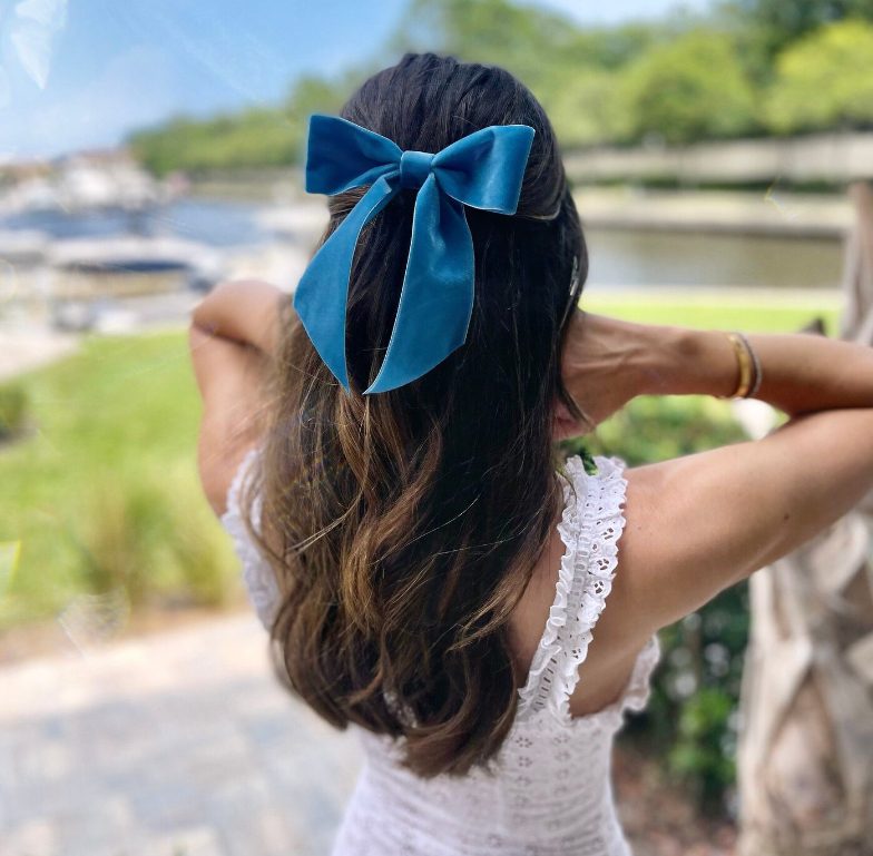 Bride wearing a navy velvet hair bow from NeverNotRetro Etsy shop